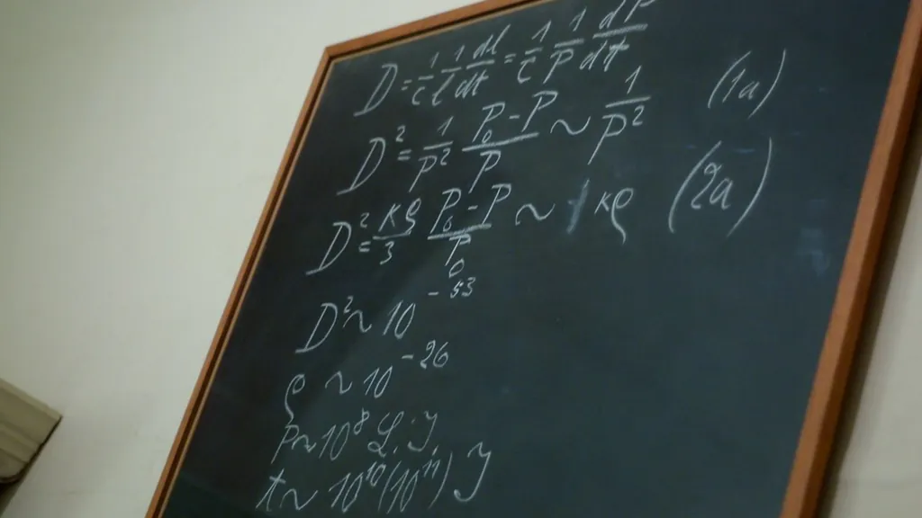 A classroom blackboard covered in hand-written mathematical equations